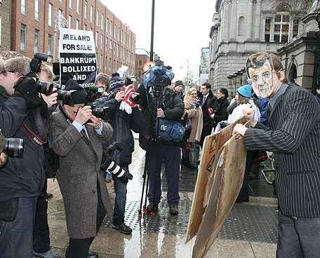 Press photographers choreograph the actor playing Brian Lenihan