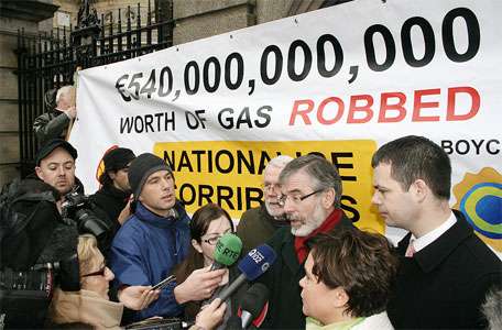 Gerry Adams speaks to a large media scrum